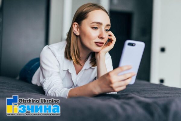 relaxed woman home reading text message her bright bedroom