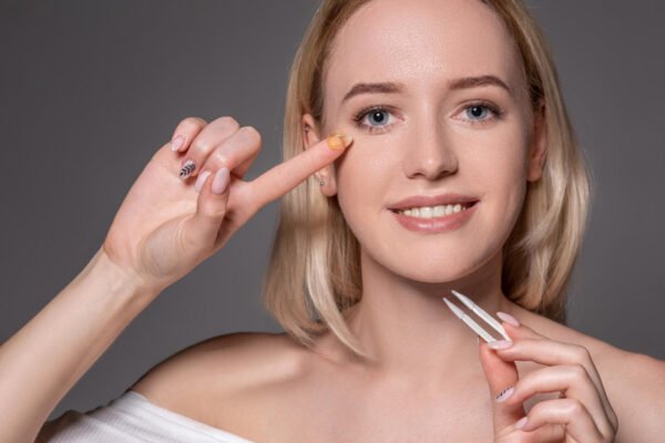 portrait young beautiful woman with natural makeup contact eye lens hand close up female model holding white tweezers contact lenses eye care healthy lifestyle eyes health