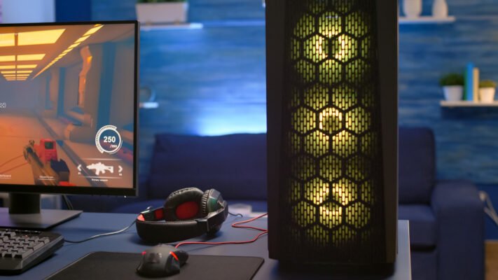 close up rgb system desktop pro gamer playing first person shooter video game during online competition streaming studio is equipped with professional setup with powerful pc ready online game