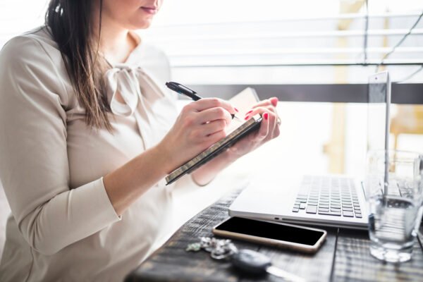 businesswoman writing diary