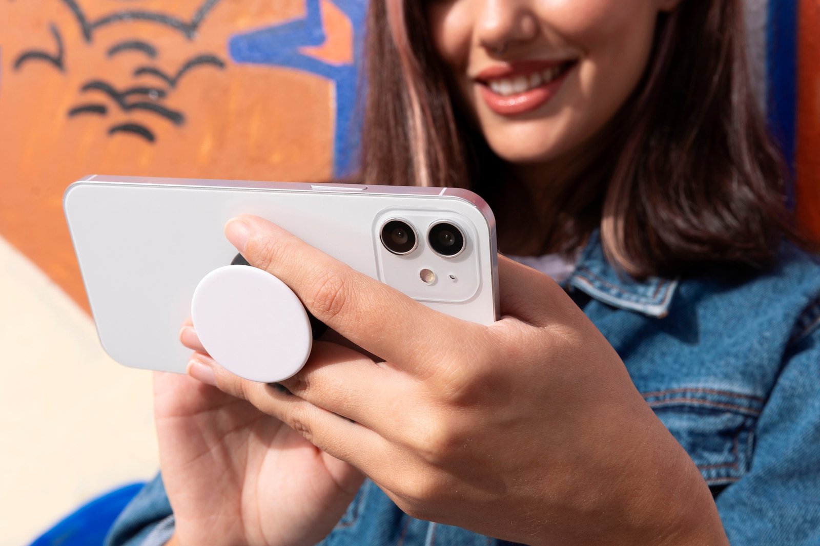 woman using smartphone with pop socket